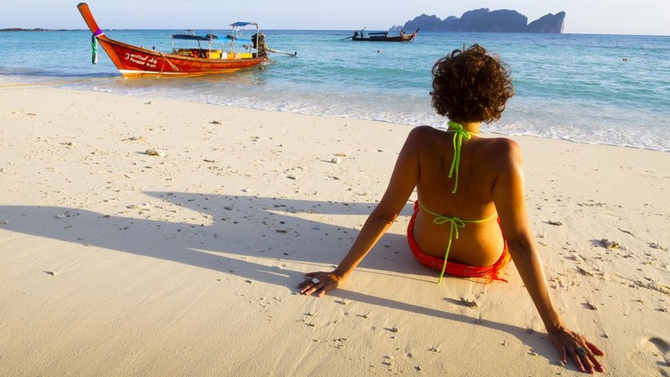 A woman relaxes on a beach in Thailand. File photo