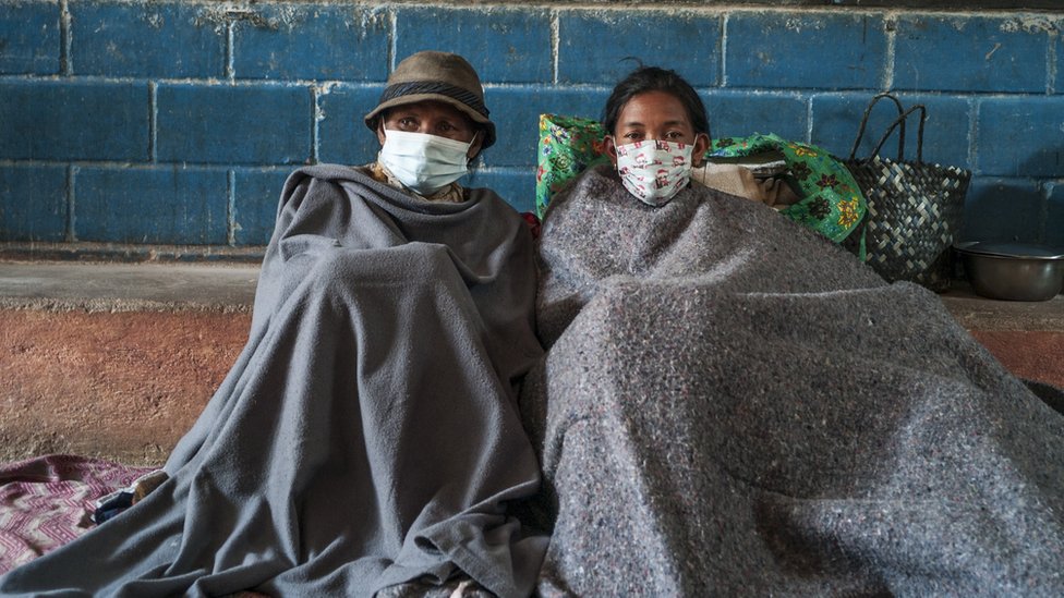 Two Madagascans sitting in a school building