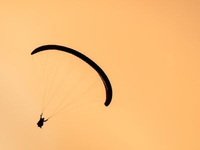 silhouette of paraglider tandem flying in orange s 2021 08 26 17 00 57 utc новости Гудаури