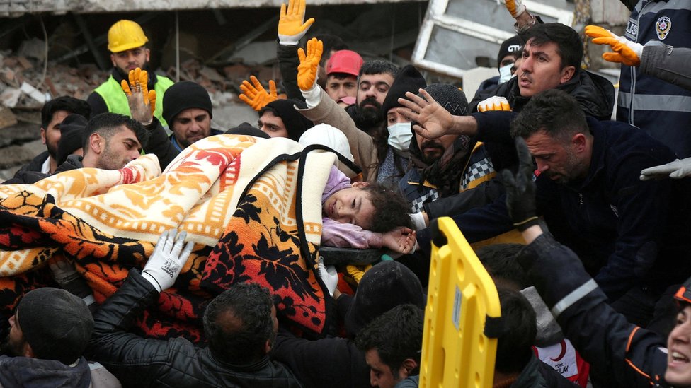 Rescuers carry out a girl from a collapsed building following an earthquake in Diyarbakir, Turkey, on 6 February 2023