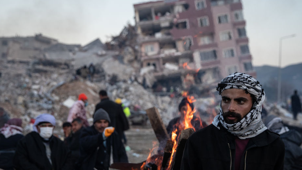 People wait for news of their loved ones, believed to be trapped under collapsed buildings on February 09, 2023 in Hatay, Turkey