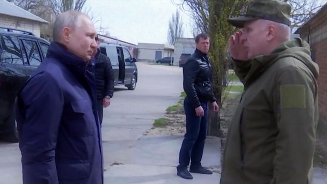 Russian President Vladimir Putin being saluted to