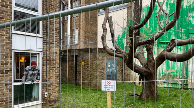 Carlos Serrano near to the Banksy mural in London's Finsbury Park