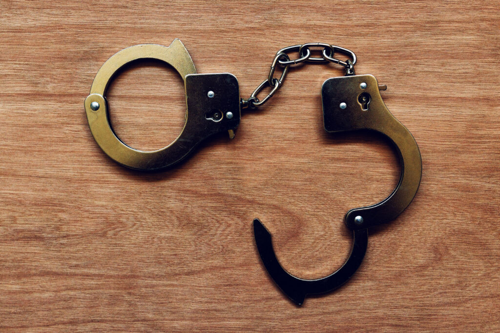 handcuffs on wooden background 2024 12 06 12 34 34 utc политика 4 октября, featured, Георгий Чахунашвили, Грузинская мечта