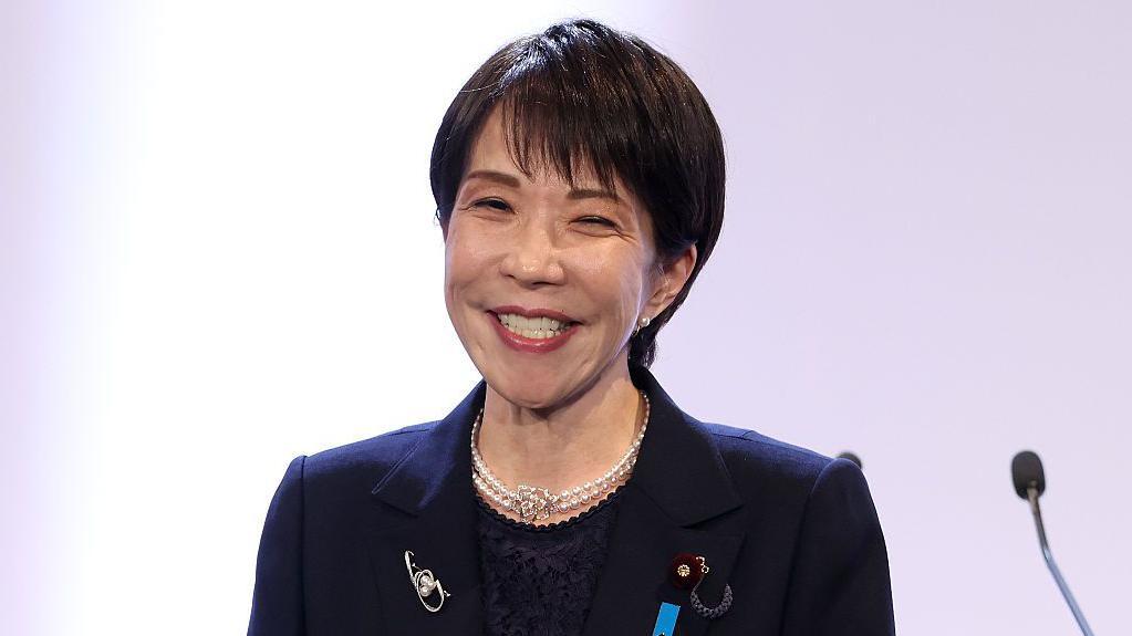 Санаэ Такаити, премьер-министр Японии и председатель Либерально-демократической партии (ЛДП), исполняет гимн партии во время ежегодного съезда партии в Токио, Япония, в воскресенье, 12 апреля 2026 года.