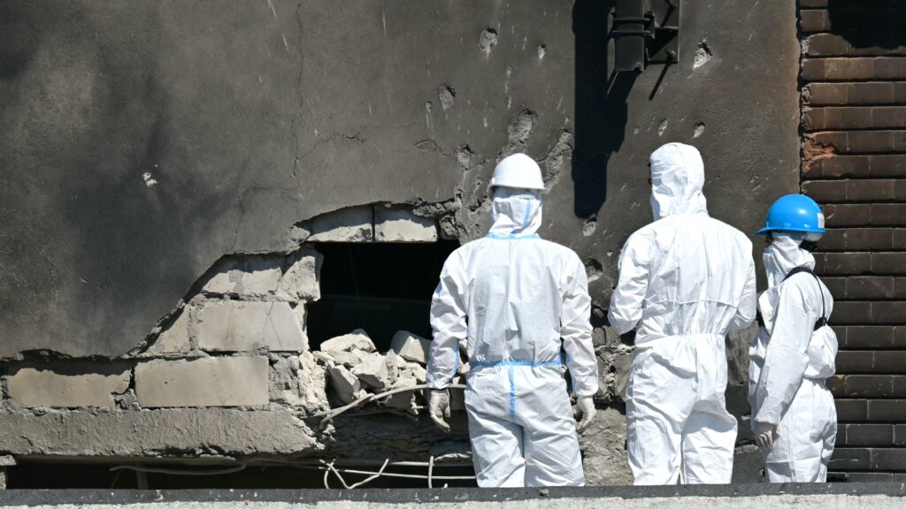 Forensic investigators examine the location of impact after a Russian drone struck an apartment building in Galati, eastern Romania
