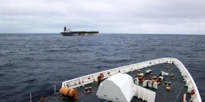 Вид с носа корабля на танкер в море