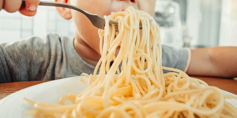 Child eating pasta