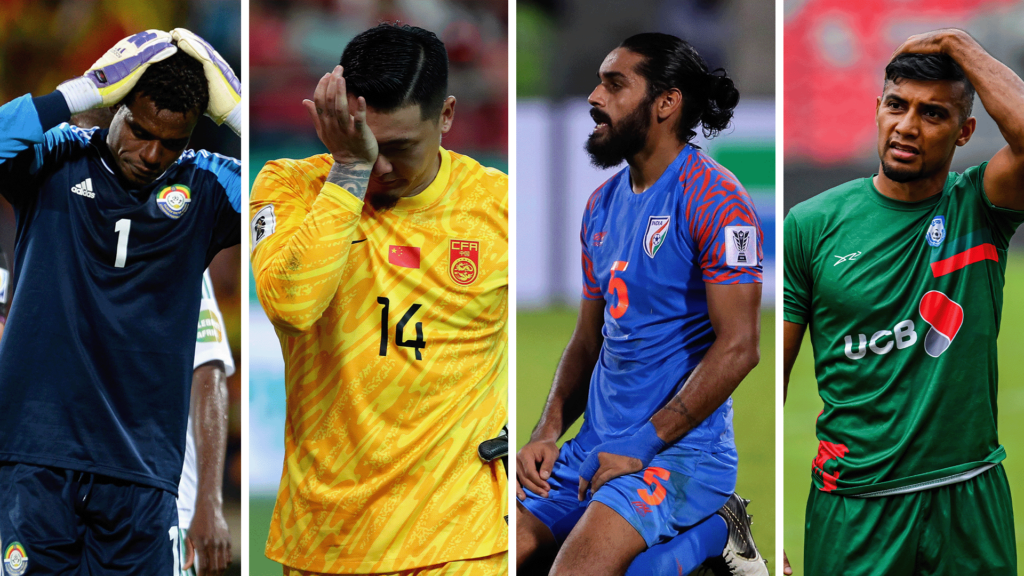 Four football players all express disappointment in defeat: a goalkeeper holds his head in his gloved hands, another presses his palm into his eye, an outfield player kneels with a look of disconsolation on his face, and the fourth rubs his head with a puzzled expression.