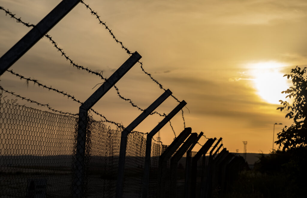 barbed wire fence against a fiery orange sky 2026 09 23 19 52 49 utc News