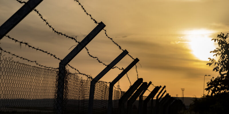 barbed wire fence against a fiery orange sky 2026 09 23 19 52 49 utc News