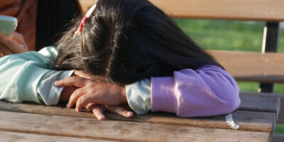 child resting head on wooden table outside 2026 09 23 07 11 33 utc новости